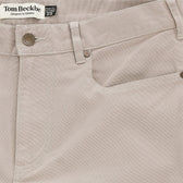 Close-up of Tom Beckbe's Reid Straight Leg Cotton Chino Pant with front pocket, belt loops, and logo label.