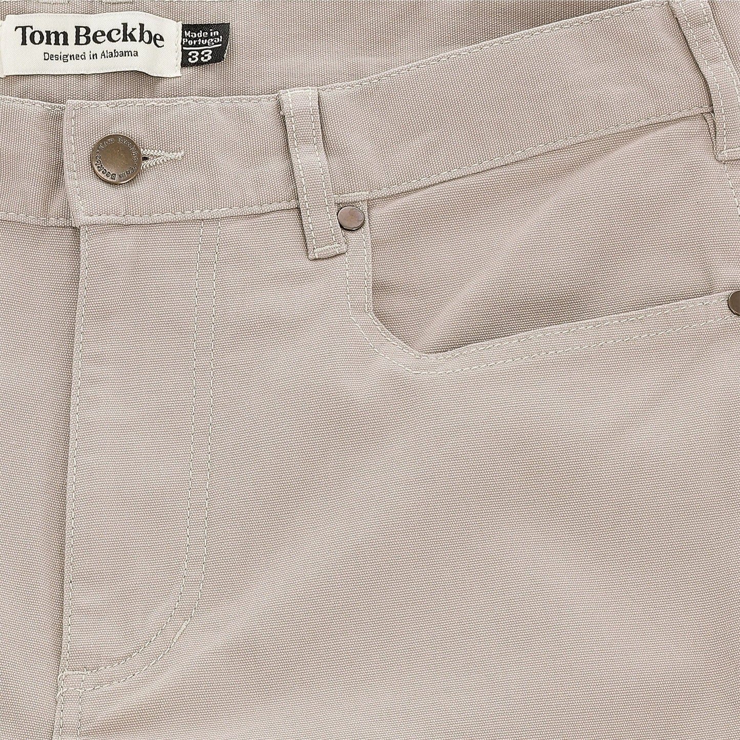 Close-up of Tom Beckbe's Reid Straight Leg Cotton Chino Pant with front pocket, belt loops, and logo label.