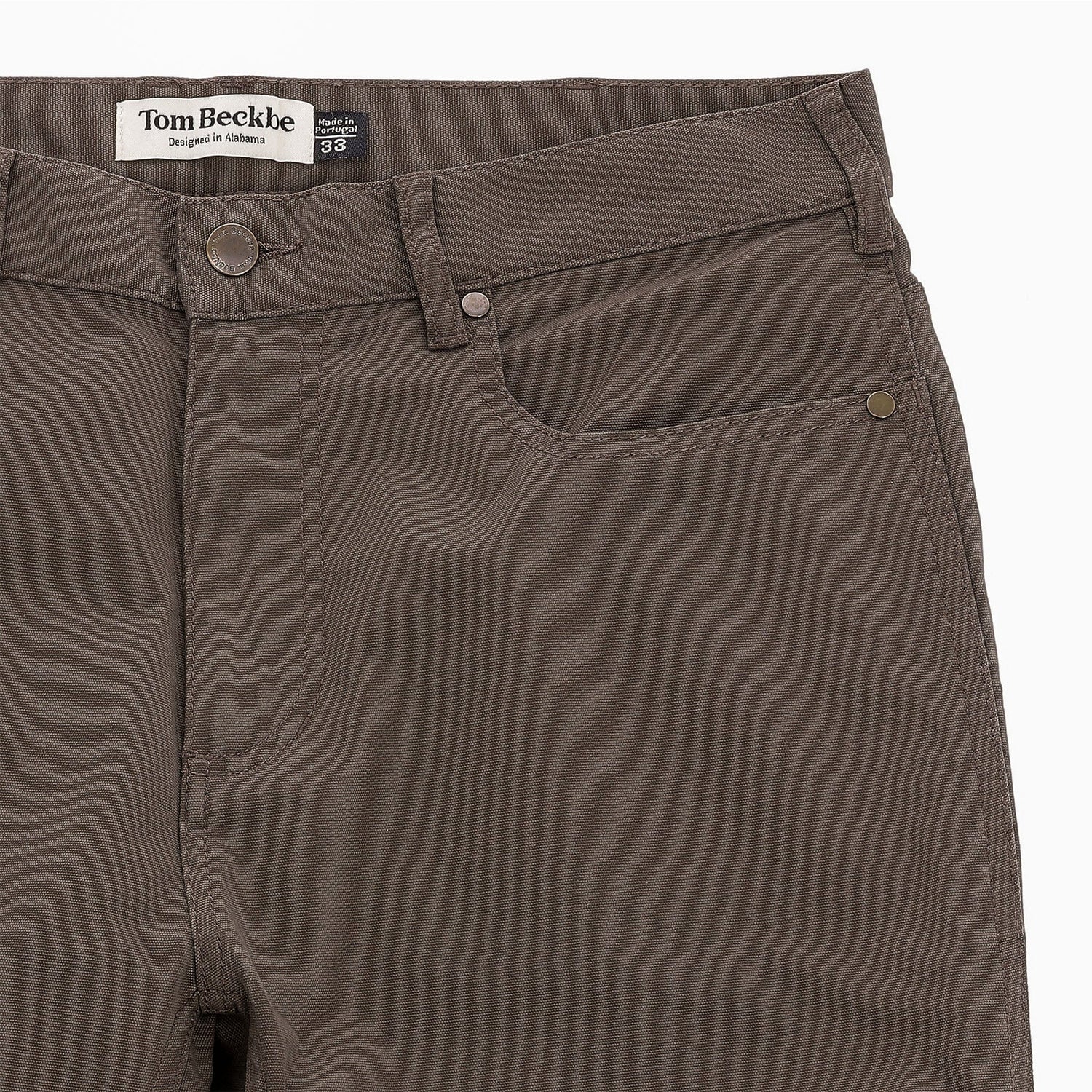 Close-up of Tom Beckbe Reid Straight Leg Cotton Chino Pant with front pockets, belt loops, and brand label.