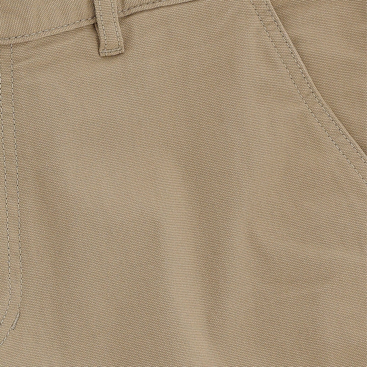 Close-up of Tom Beckbes Reid Short in khaki, highlighting the belt loop, front pocket seam detail, and brass zip fly.