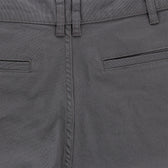 Close-up of mid-rise Tom Beckbe Reid Shorts with belt loops, welt pockets, and antique brass zip fly.