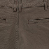 Close-up of Tom Beckbes Reid Short in mid-rise brown with waistband, belt loops, brass zip fly, and two closed welt pockets.