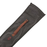 The Tom Beckbe Canvas Roll Top Gun Sleeve features a dark finish, brown strap, and oval leather patch—ideal for gear.