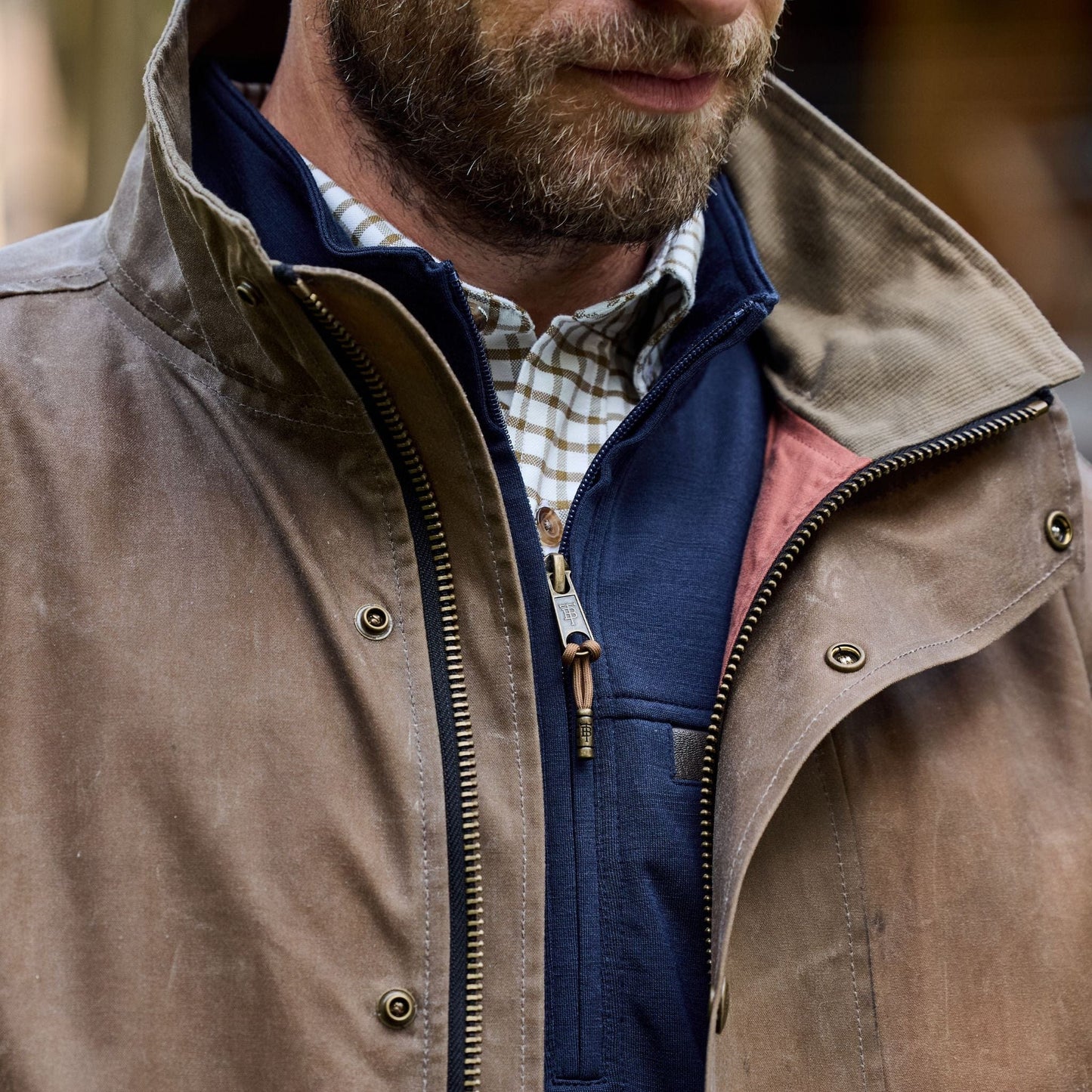 Man in a Tom Beckbe Tensaw Jacket made from durable shelter cloth over a checkered shirt, highlighting the collar and chest.