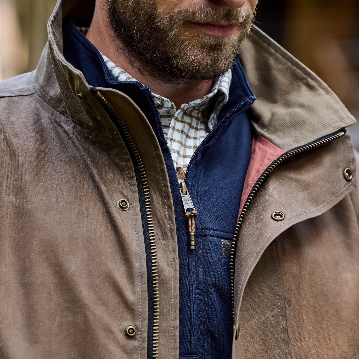 Man in a Tom Beckbe Tensaw Jacket made from durable shelter cloth over a checkered shirt, highlighting the collar and chest.