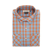 The Tom Beckbe Tidewater Shirt in orange and blue plaid offers UPF 30+ and features a neatly folded collar and pockets.