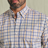 A man wears the Tom Beckbe Tidewater Shirt, a lightweight blue, yellow, and white plaid outdoor shirt with chest pockets.