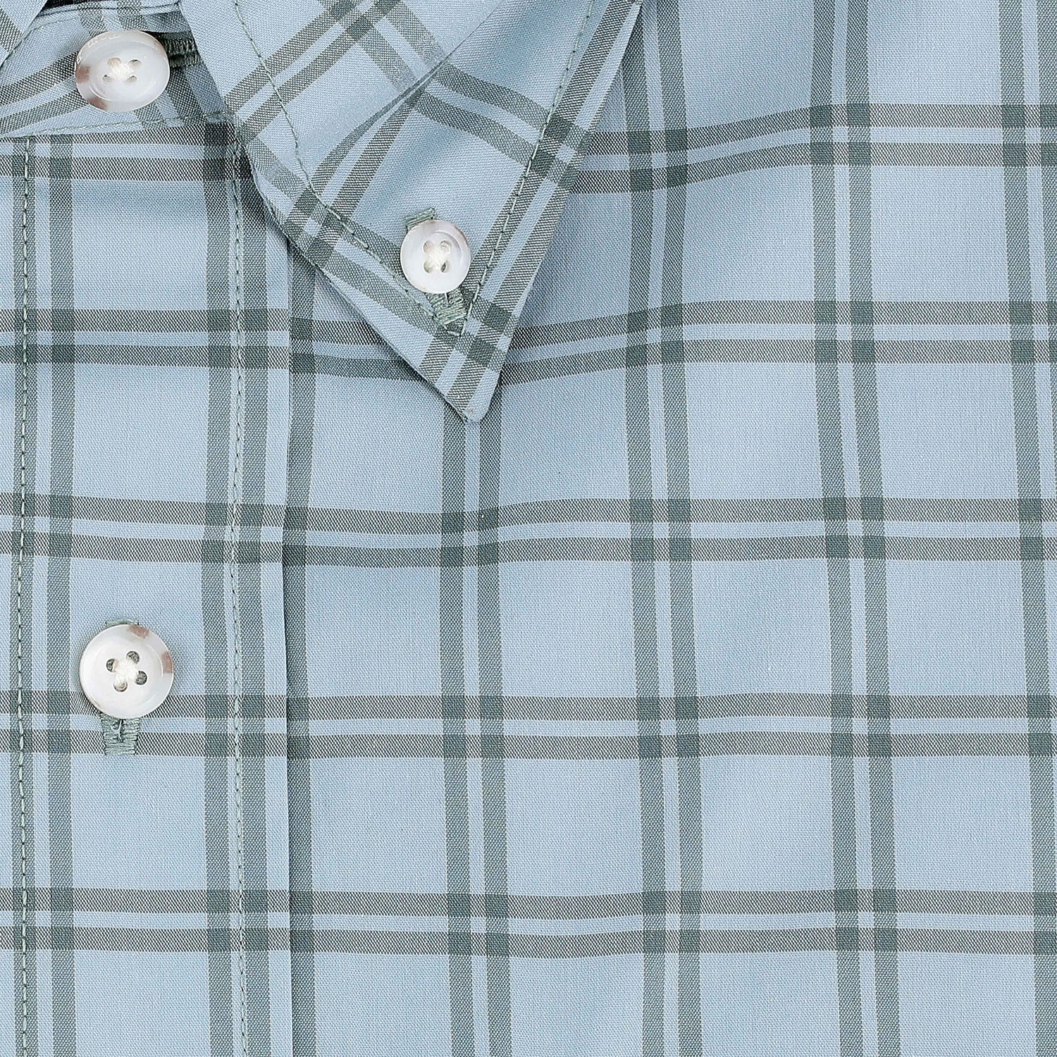 Close-up of the Tom Beckbe Tidewater Shirt, a light blue plaid outdoor shirt with white buttons and pointed collar.