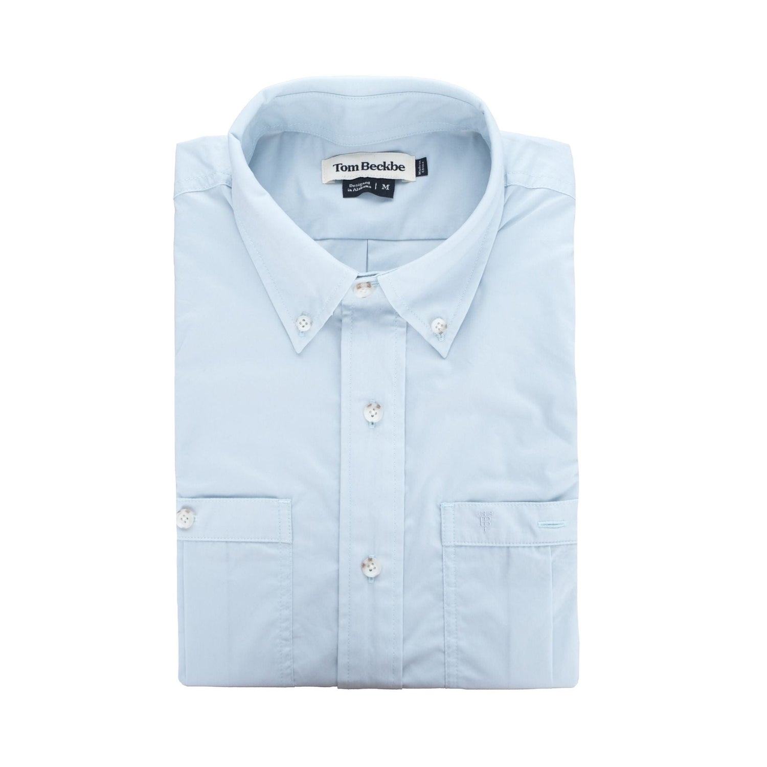 Tom Beckbes Tidewater Shirt: Light blue button-up with front pocket, buttoned collar, UPF 30+ and small tag inside.