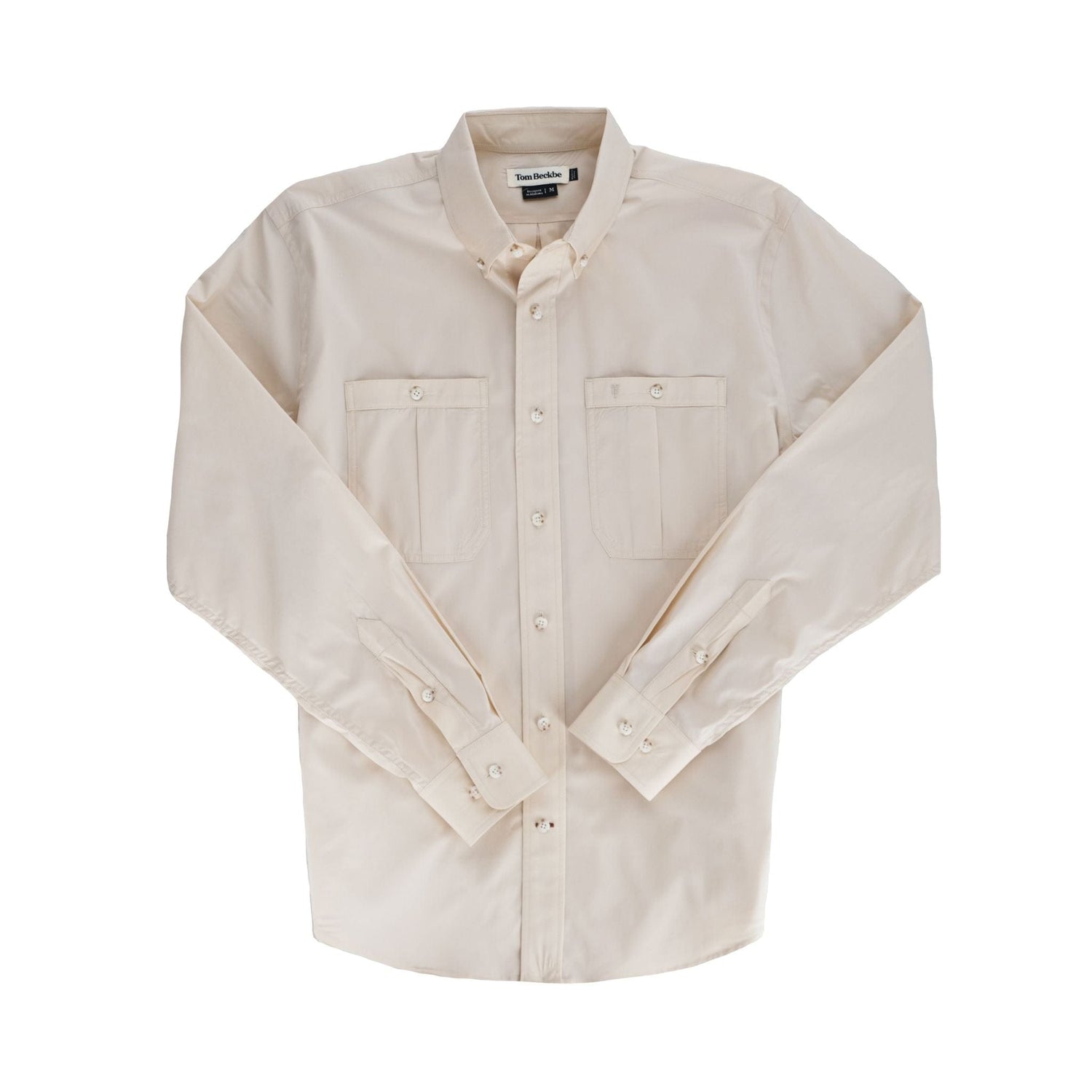 A beige Tom Beckbe Tidewater Shirt, UPF 30+, with two chest pockets, laid flat on a white background.