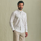 Man wears the Tom Beckbe Tidewater Shirt with khaki pants, standing in front of a plain beige background.