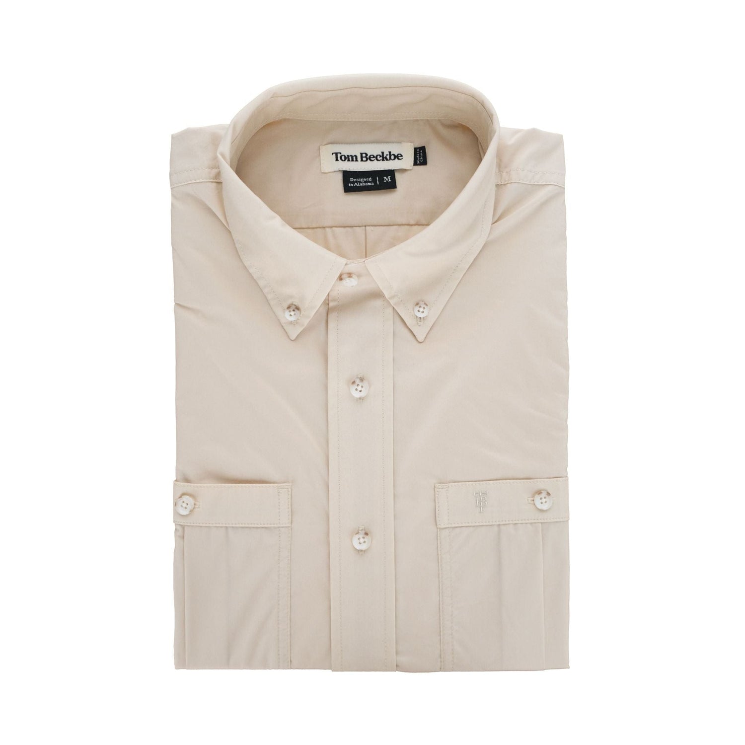 The Tidewater Shirt by Tom Beckbe is a lightweight beige button-up with UPF 30+, a button-down collar, and brand label inside.