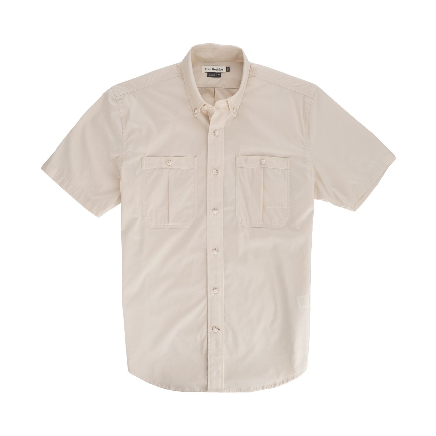 Tom Beckbes Tidewater Shirt: Beige, short-sleeve fishing shirt with UPF 30+ and two chest pockets on a white background.