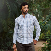 Man outdoors among greenery, wearing Tom Beckbe's Tidewater Shirt (UPF 30+) and khaki pants.