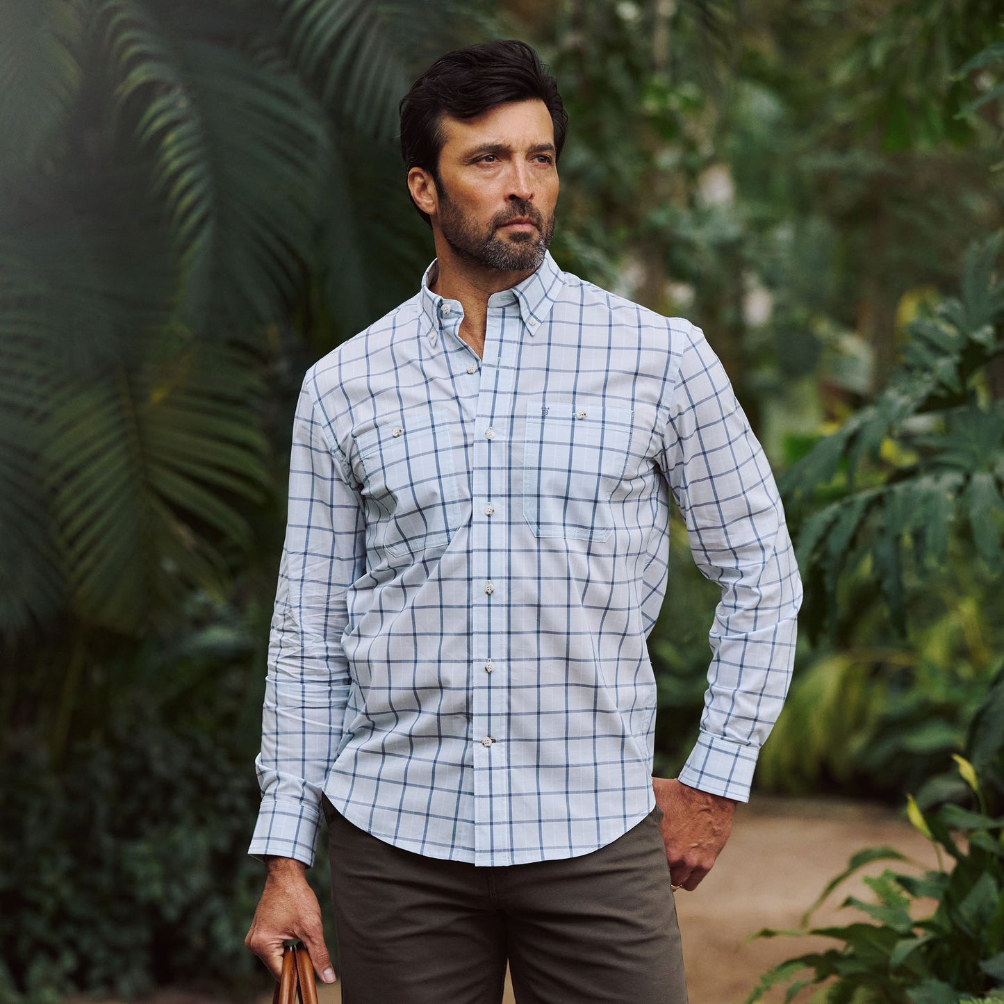 Man outdoors among greenery, wearing Tom Beckbe's Tidewater Shirt (UPF 30+) and khaki pants.