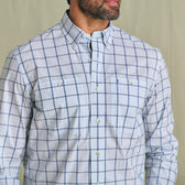 Man wearing the Tom Beckbe Tidewater Shirt, a light blue plaid long sleeve with two chest pockets, shown shoulders to waist.