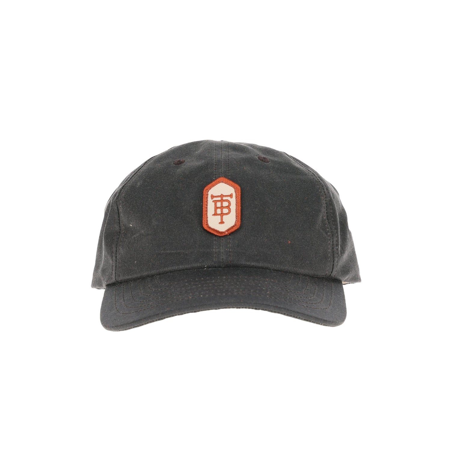 Tom Beckbes Waxed Cotton 6-Panel Hat in black with a geometric patch in red and white embroidery.