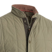 Close-up of the Tom Beckbe Burgess Quilted Vest in olive with brown collar lining, zipper, and snap button closure.