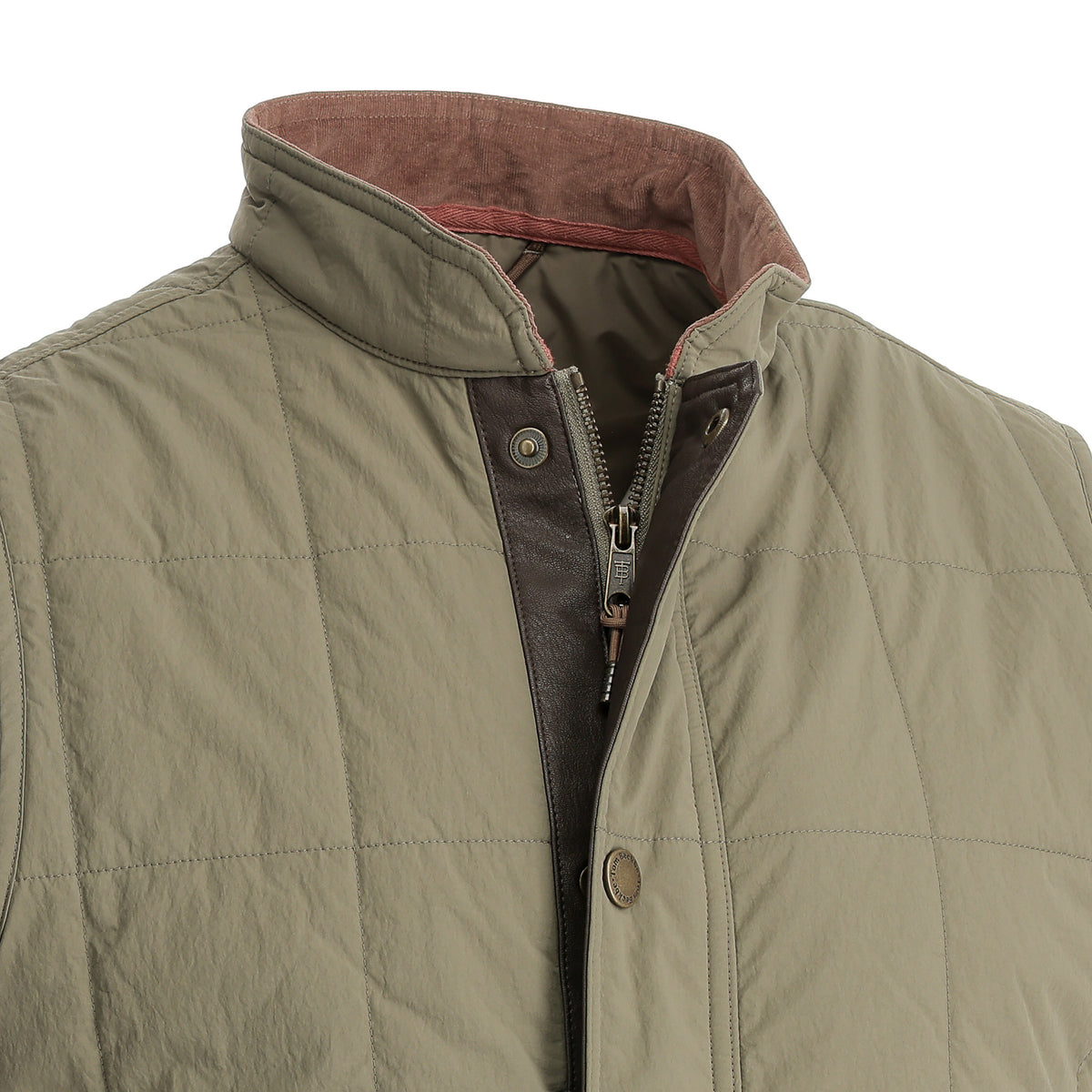 Close-up of the Tom Beckbe Burgess Quilted Vest in olive with brown collar lining, zipper, and snap button closure.