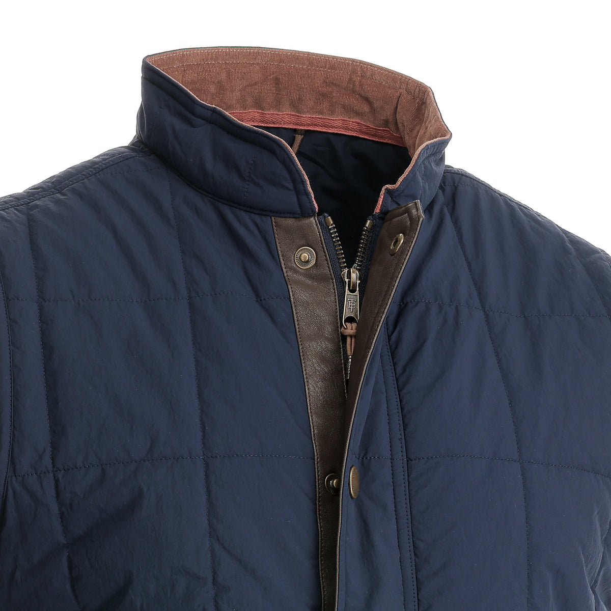 Tom Beckbe Burgess Quilted Vest in navy blue with stand collar, brown lining, zipper, and snap closure shown chest up.