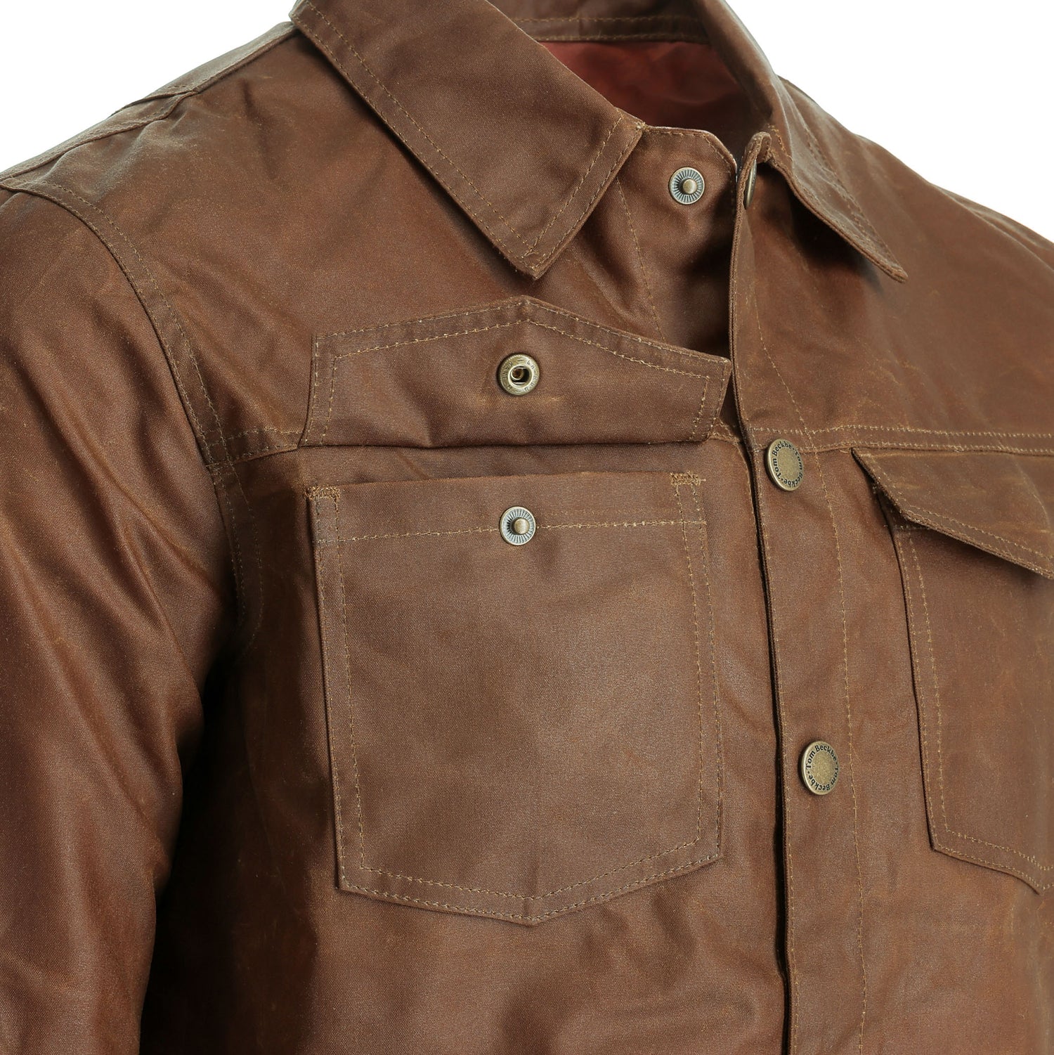 Close-up of the Tom Beckbe Chatom Jacket, a men’s brown waxed jacket with buttons and chest pockets.