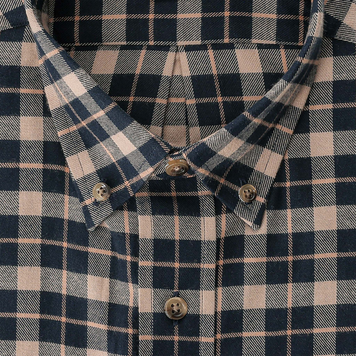 Close-up of a buttoned plaid shirt collar in navy blue and beige with a checkered pattern and brown buttons.