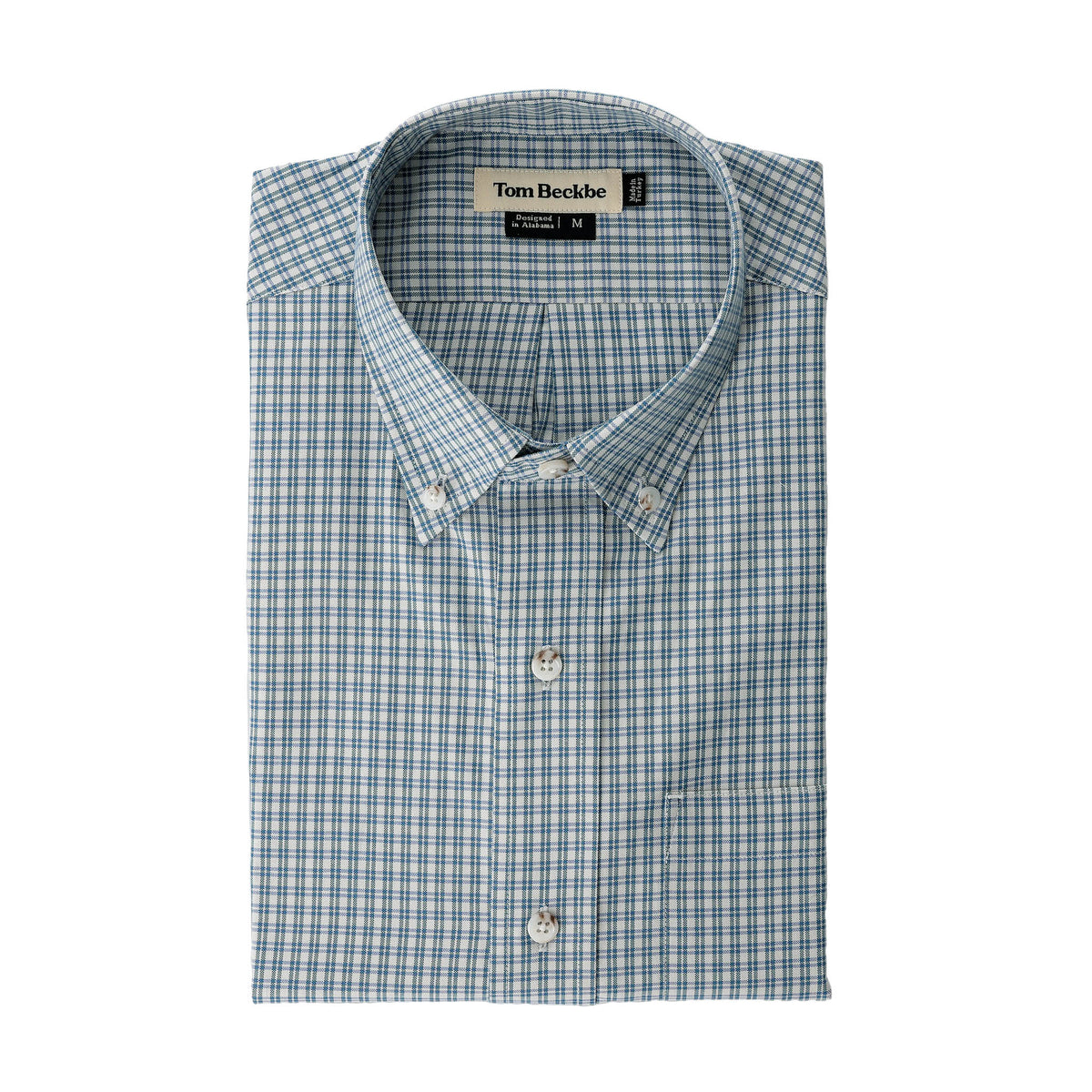 Folded Ensley Pinpoint Oxford Shirt in light blue and white with Tom Beckbe label visible at the collar.