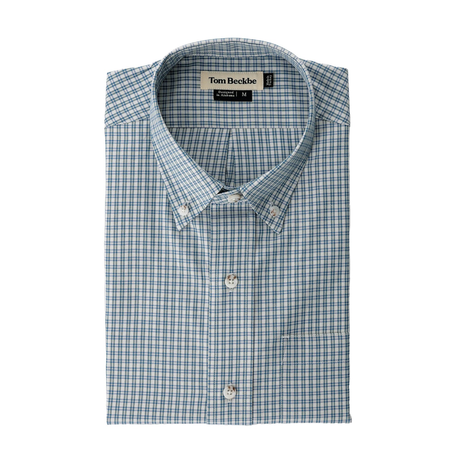 Folded Ensley Pinpoint Oxford Shirt in light blue and white with Tom Beckbe label visible at the collar.