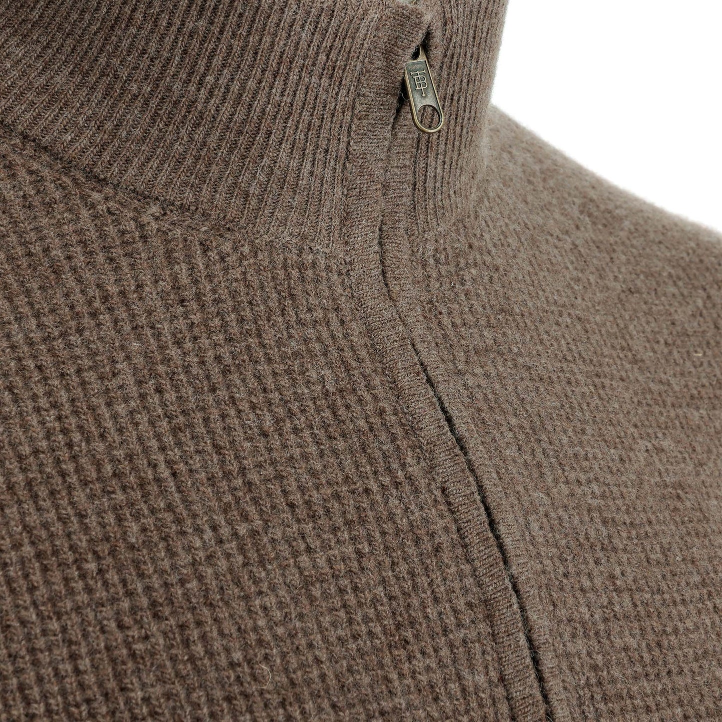 Close-up of the Tom Beckbe Farris Waffle Knit Quarter Zip featuring a brown knit and small metal half-zip pull.