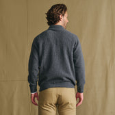 Man facing away in a Tom Beckbe Farris Waffle Knit Quarter Zip and khaki pants, set against a beige background.