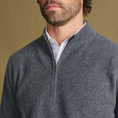 Man wears Tom Beckbe Farris Waffle Knit Quarter Zip over a white shirt, shown shoulders to chin, plain background.