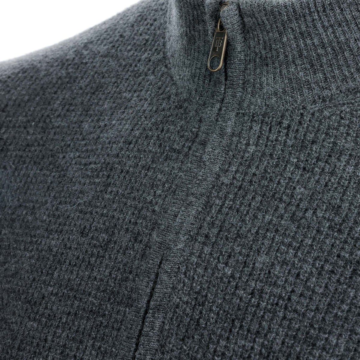 Close-up of the Tom Beckbe Farris Waffle Knit Quarter Zip, a textured dark gray men’s wool sweater.