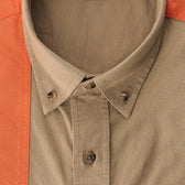 Close-up of the Perry Field Shirt collar by Tom Beckbe in tan, partially covered by an orange garment.