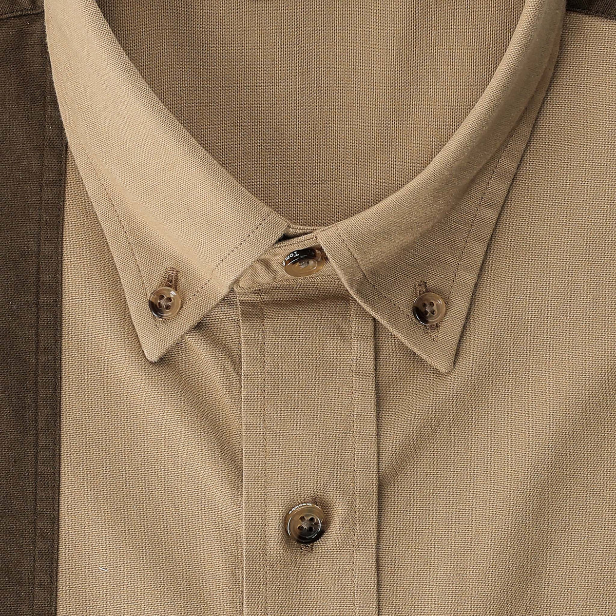 Close-up of the Tom Beckbe Perry Field Shirt in beige with visible stitching, brown buttons, and a button-down collar.
