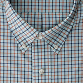 Close-up of Tom Beckbe’s Powell Performance Shirt in blue, white, and brown plaid—lightweight for sport.