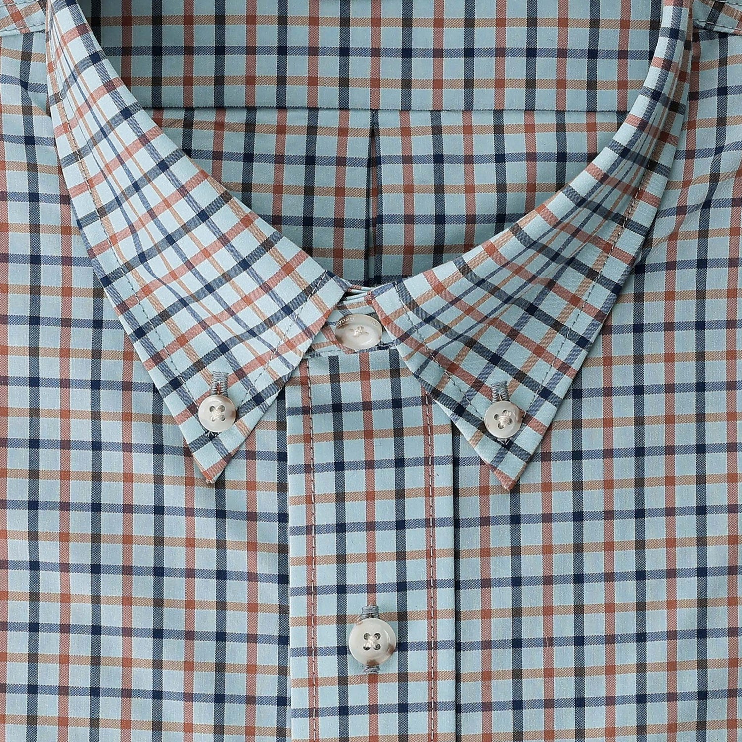 Close-up of Tom Beckbe’s Powell Performance Shirt in blue, white, and brown plaid—lightweight for sport.