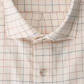 Close-up of Tom Beckbe’s Prescott Estate Twill Shirt in beige with red and blue checks, featuring a single white button.