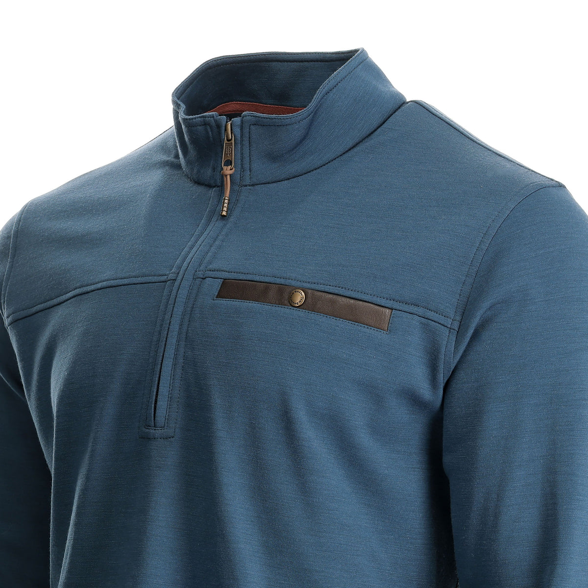 Man wears Tom Beckbe Tucker Fleece Quarter Zip in blue with a brown chest pocket, shown from shoulders up.