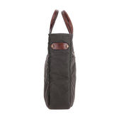 Side view of the Tom Beckbe Canvas Whiskey Tote in gray with brown handles and a patch featuring embossed initials.