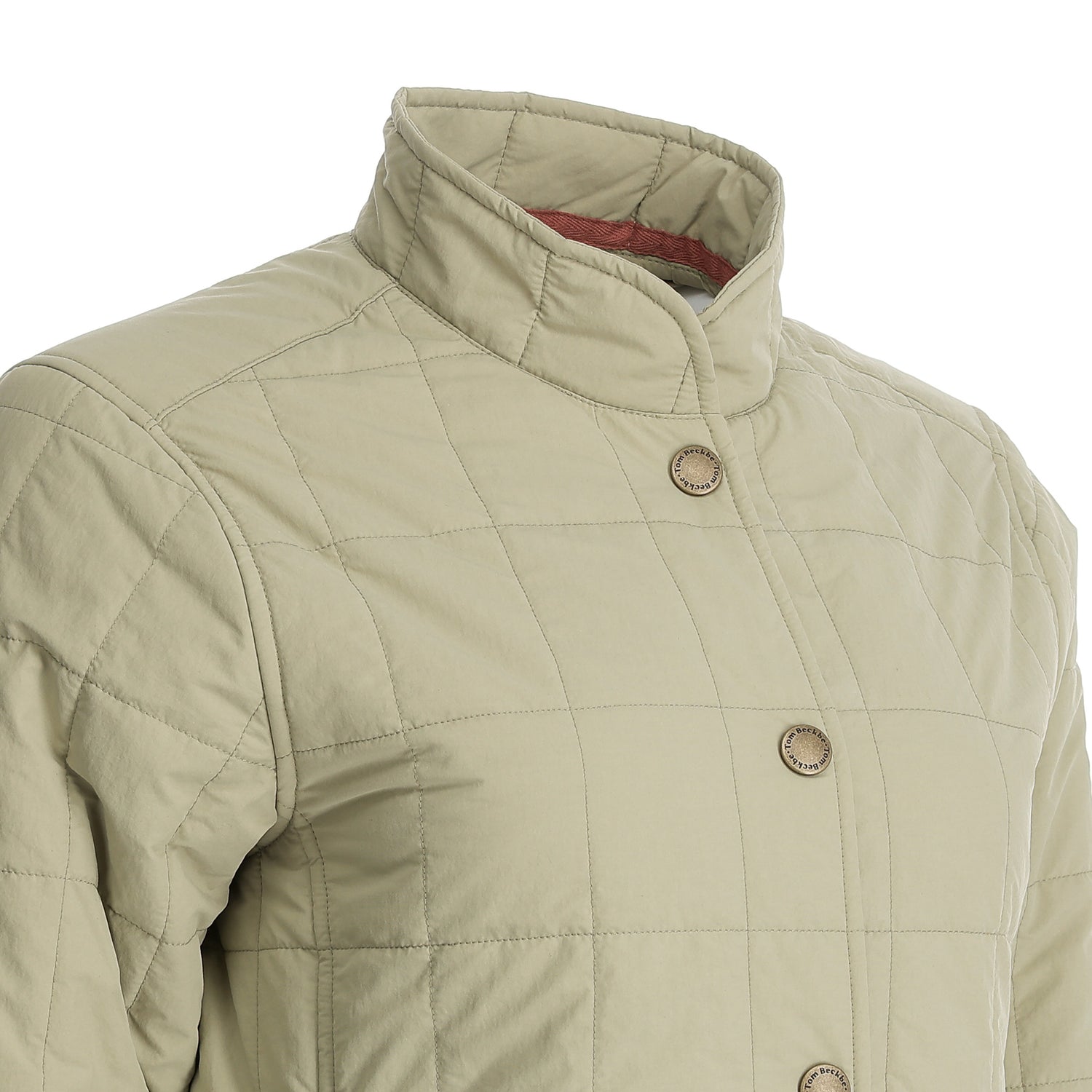 Close-up of Tom Beckbe Women’s Tyler Quilted Jacket with stand collar and button closures, shown on a mannequin.