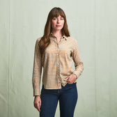 A woman stands against a plain backdrop in a Tom Beckbe Womens Smyth Cotton Twill Shirt and blue jeans.