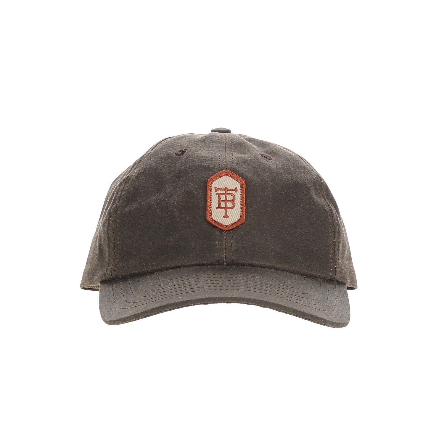 A brown Tom Beckbe Waxed Cotton 6-Panel Baseball Hat with a curved brim and central hexagonal patch featuring a stylized P logo.