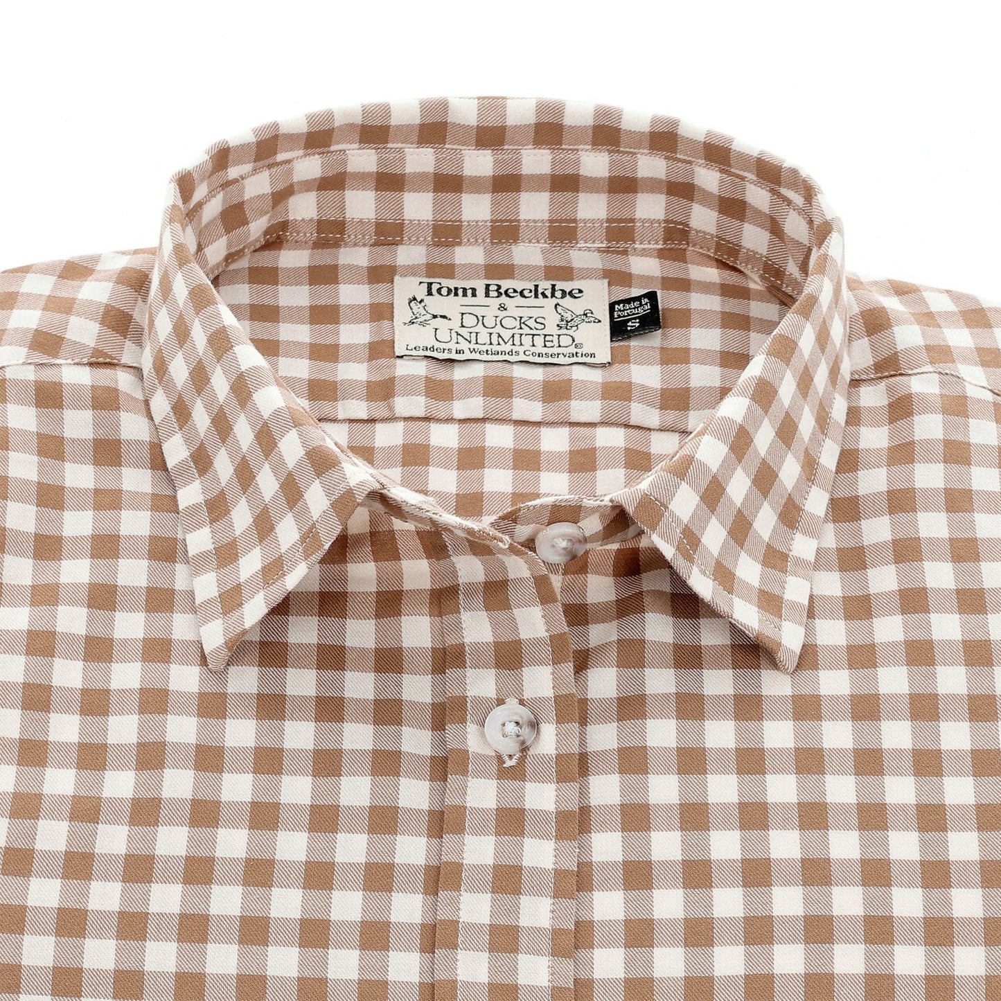 A neatly folded Womens Smyth Cotton Twill Shirt by Tom Beckbe, brown and white gingham with visible label.