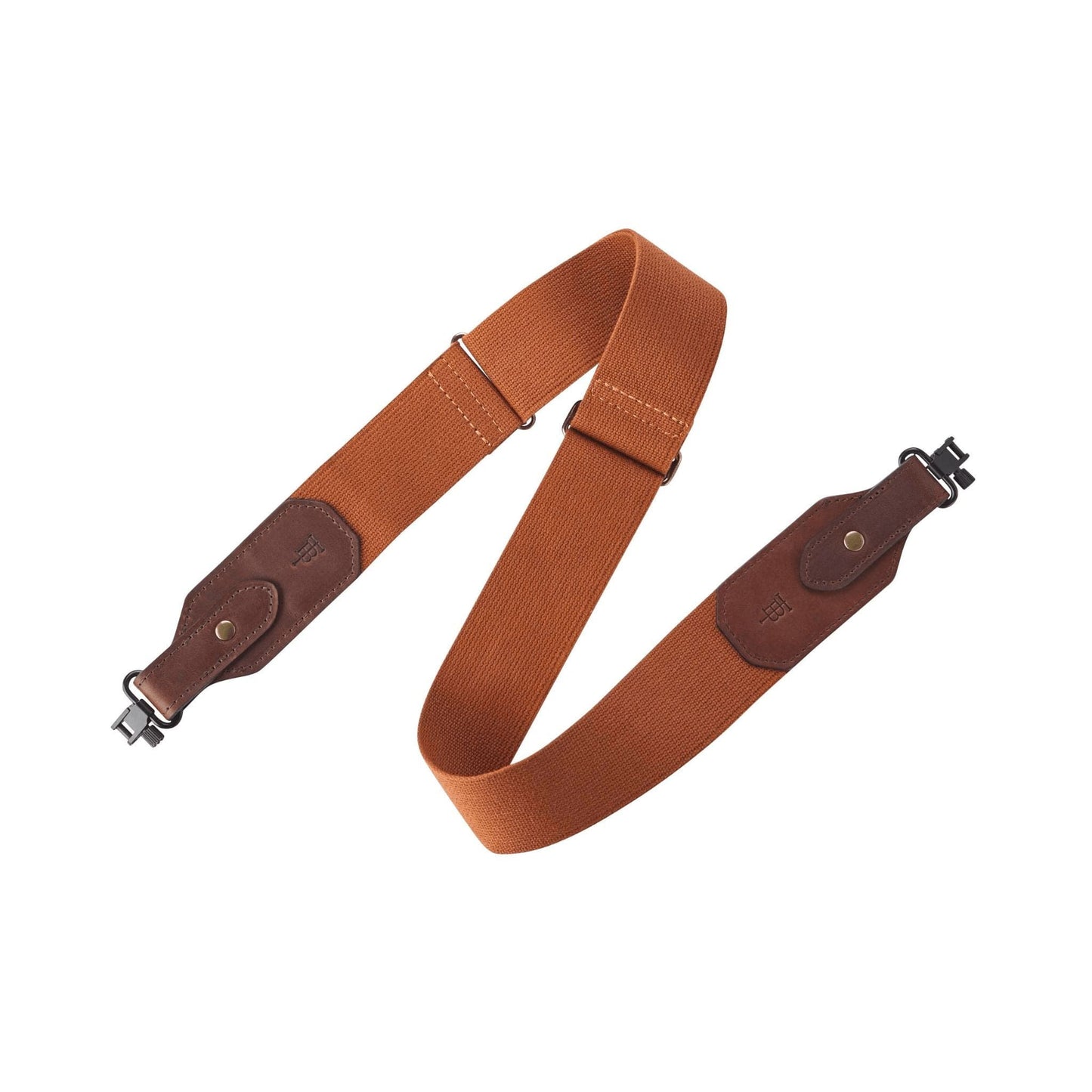 A brown Sling by Tom Beckbe with leather accents and metal clips, perfect for attaching to a bag or case.