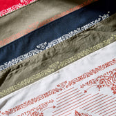 Variety of cotton bandanas featuring a western motif border with Tom Beckbe brand logo.