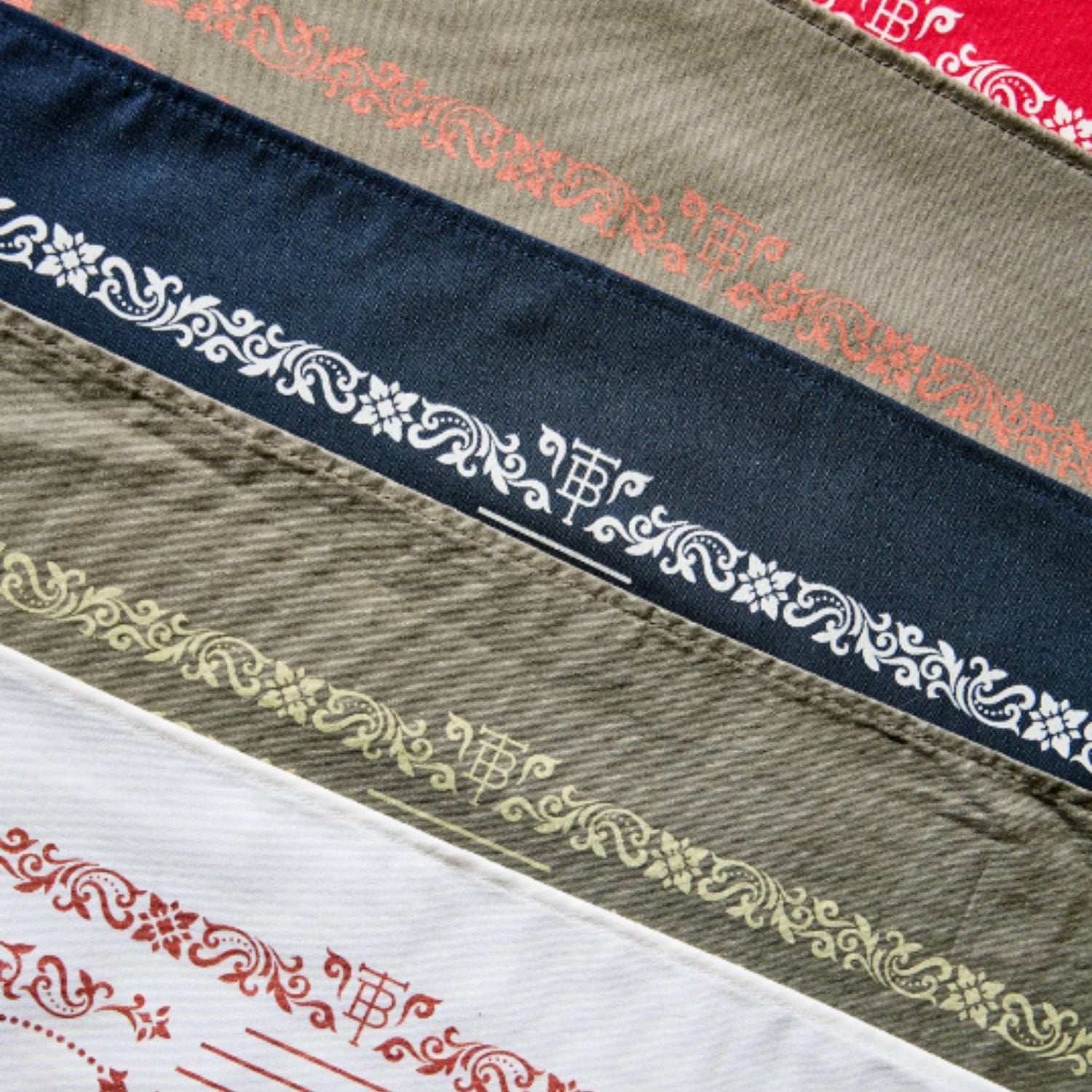 Variety of cotton bandanas featuring a western motif border with Tom Beckbe brand logo.