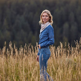 Woman in wheat field wears an ivory bandana screen printed with a classic Western American motif.